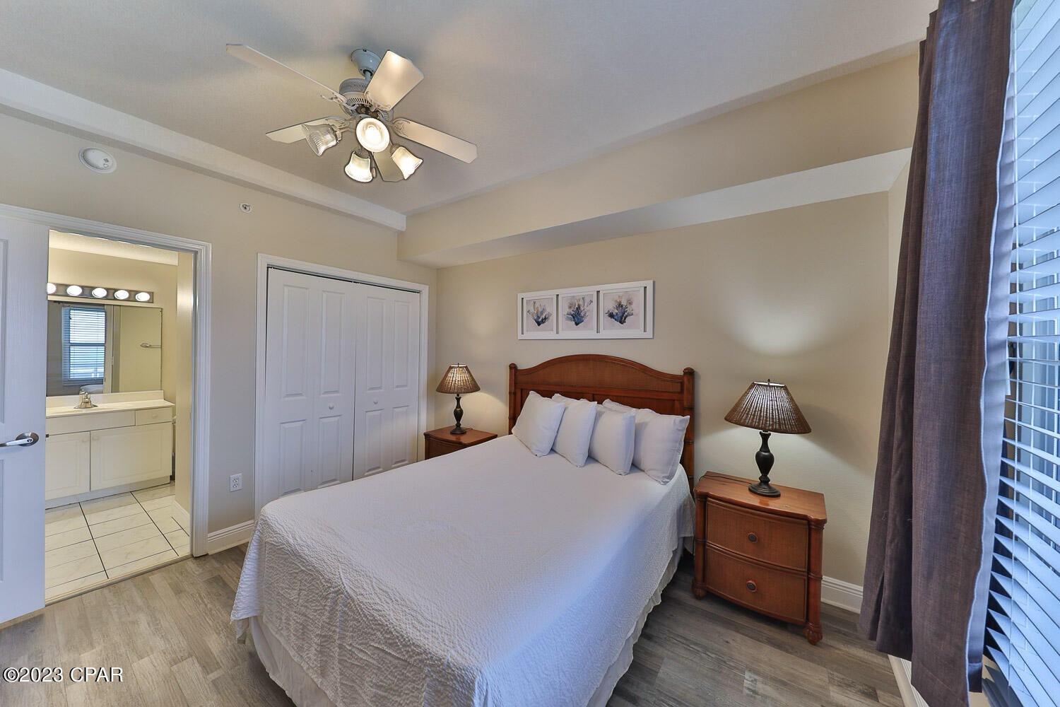 Primary guest bedroom with queen bed and walk in bathroom