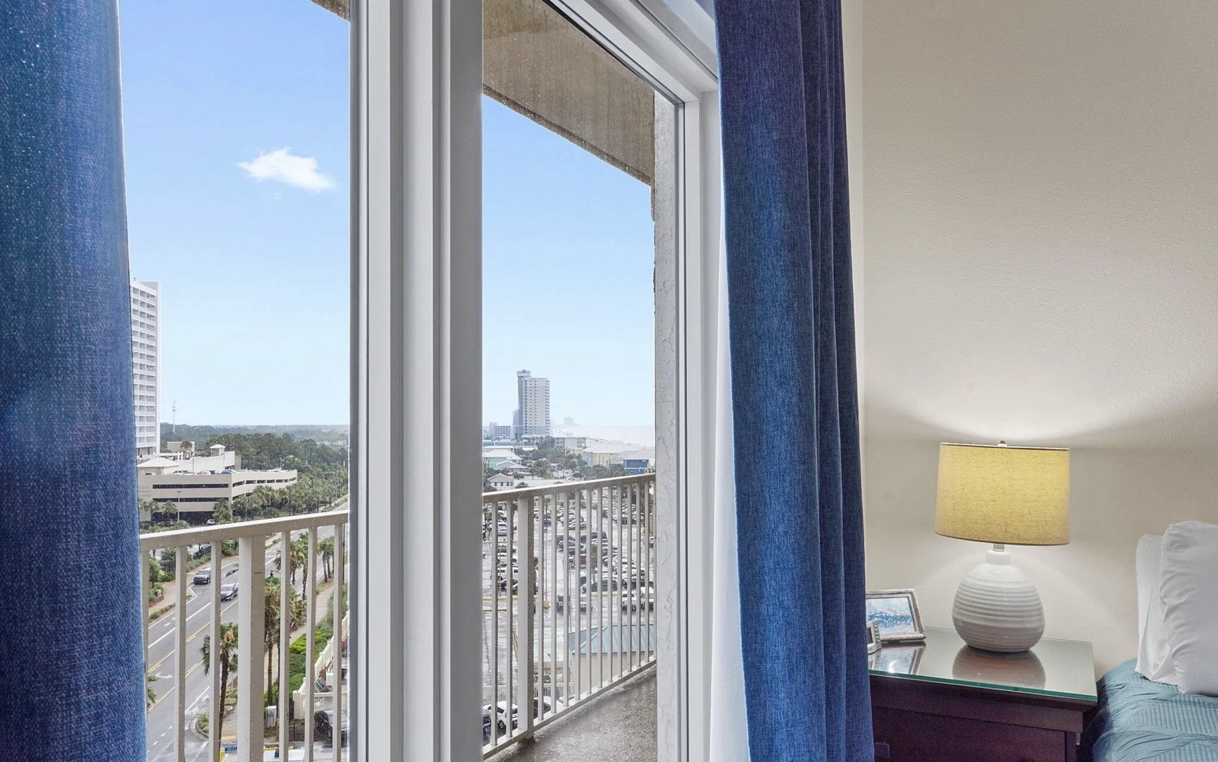 Second bedroom with king bed, TV, and scenic views.