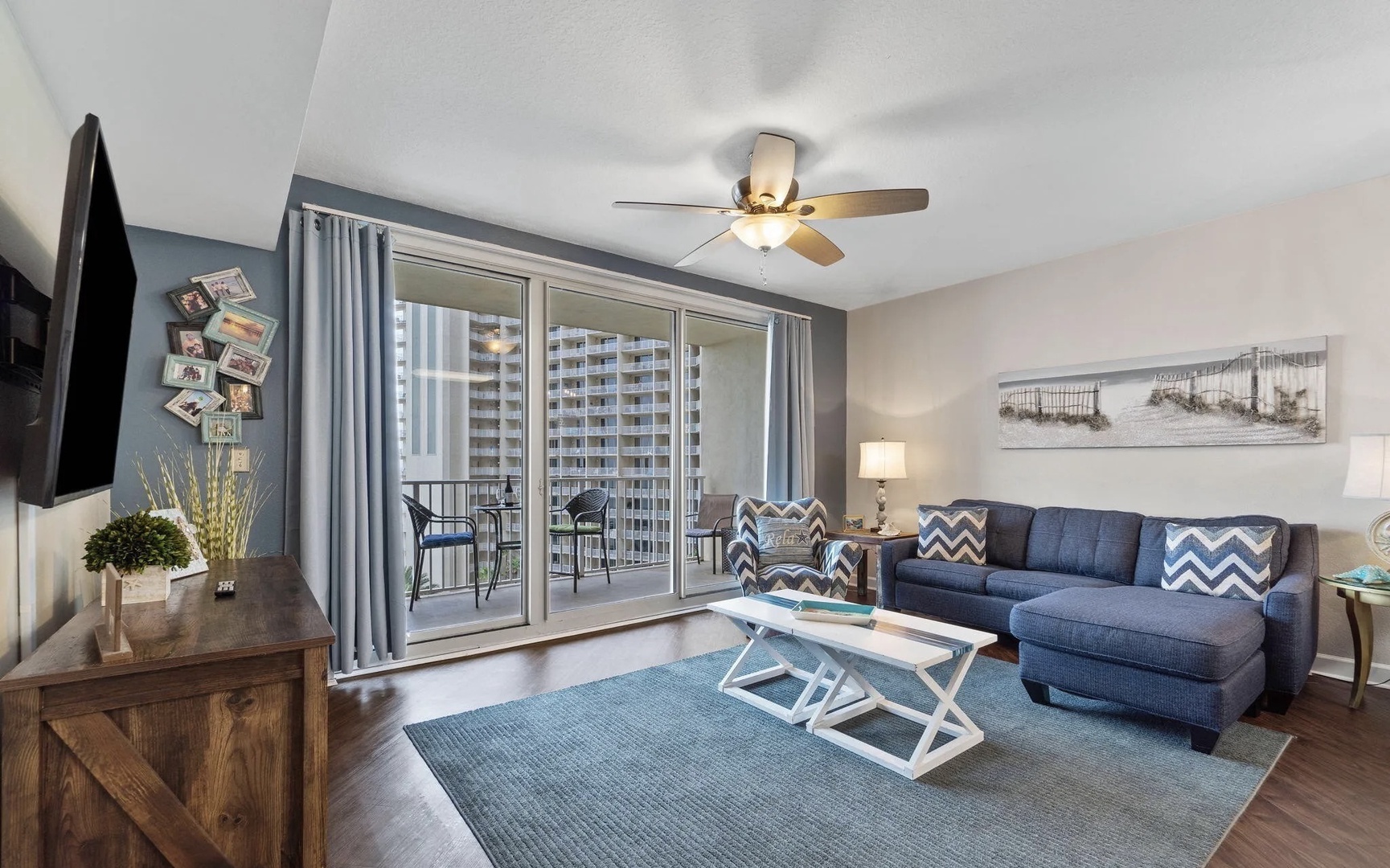 Open concept living area with stylish furnishings, TV, and scenic views. Features a queen size pullout sofa as well.