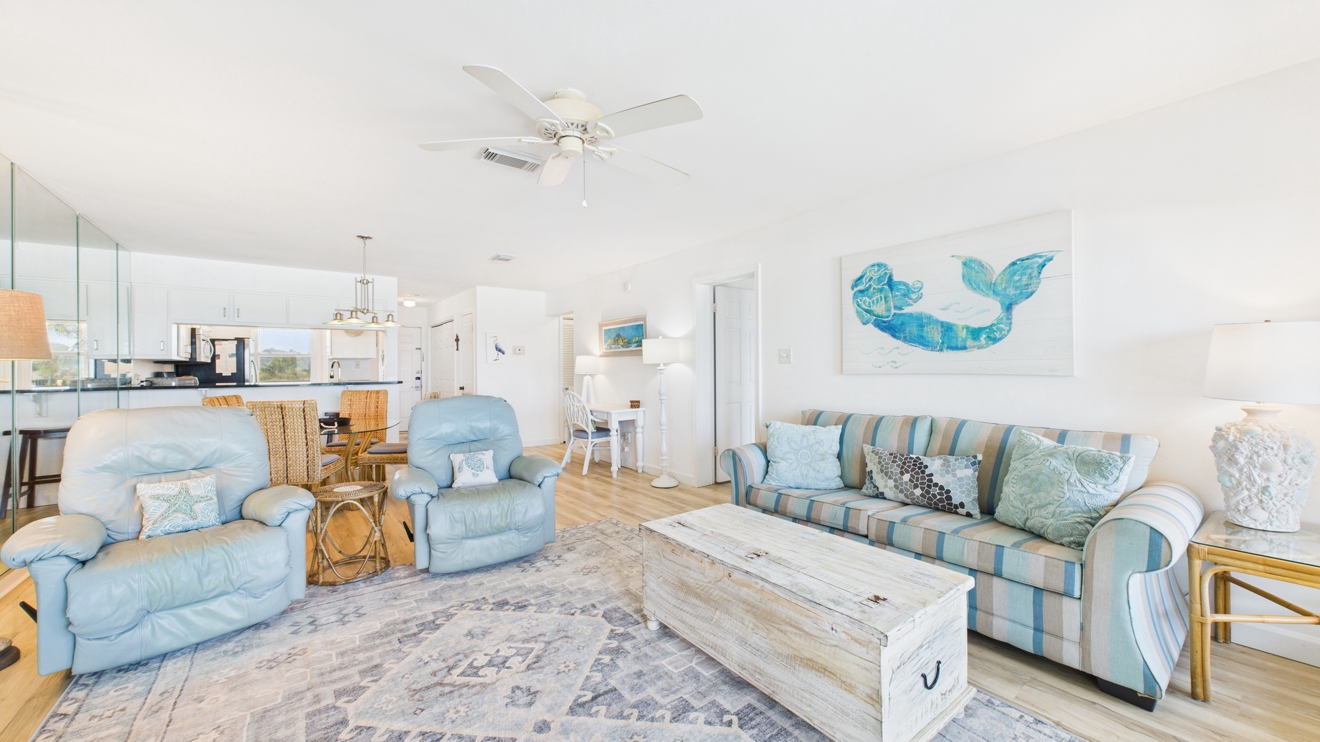 Open concept living area with stylish furnishings sleeper sofa TV and balcony access