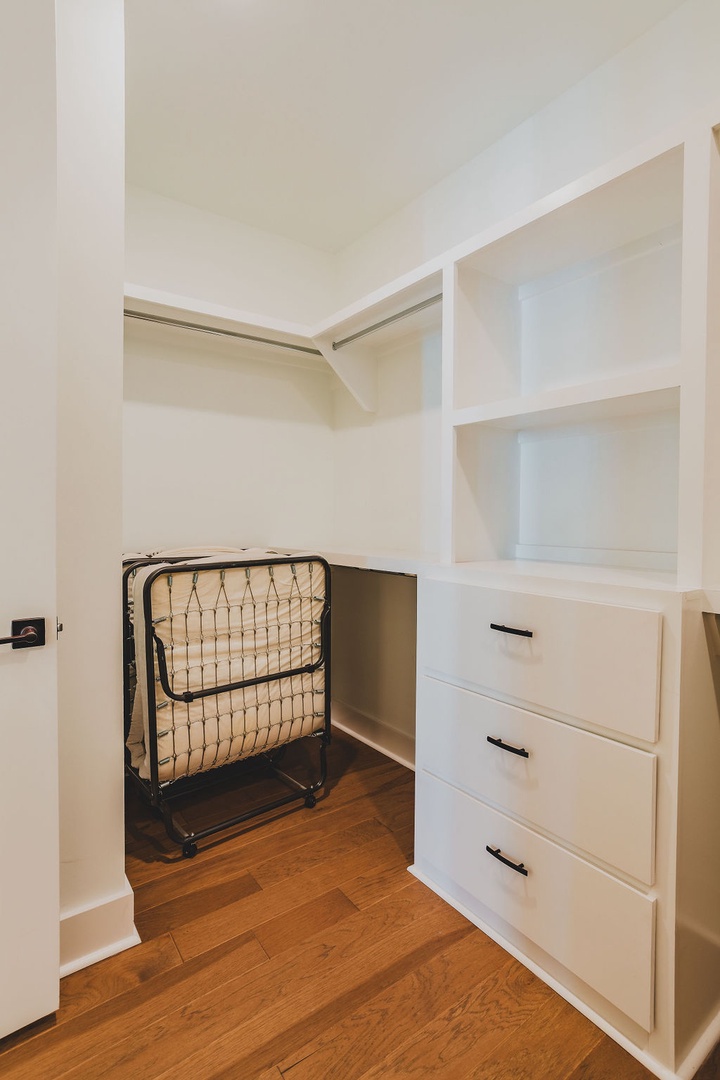 Primary bedroom walk-in closet