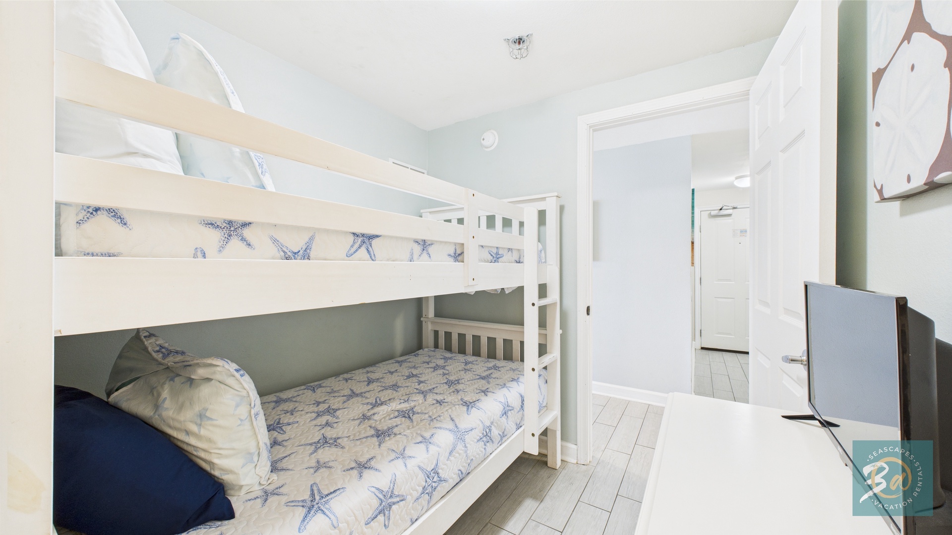 Bunk room with twin-over-twin beds in hallway and ensuite bathroom