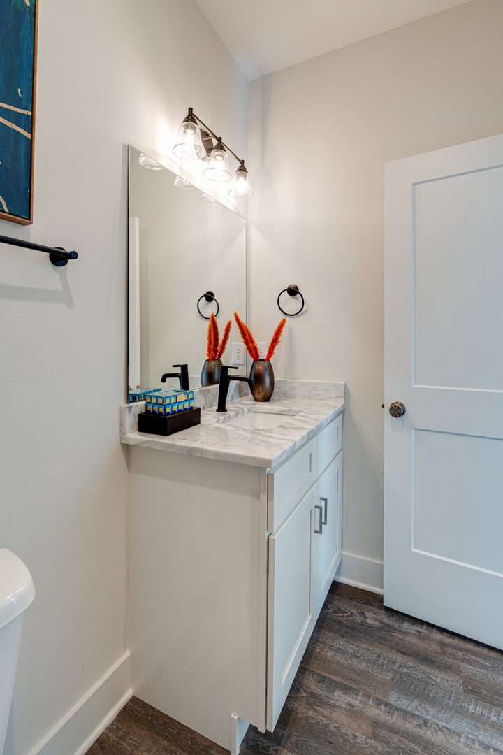 3rd bathroom that is adjacent to the 3rd bedroom. Located on the 2nd floor. Can also be used as communal bathroom for guests in living area/kitchen. Bathroom features a shower and tub combo.
