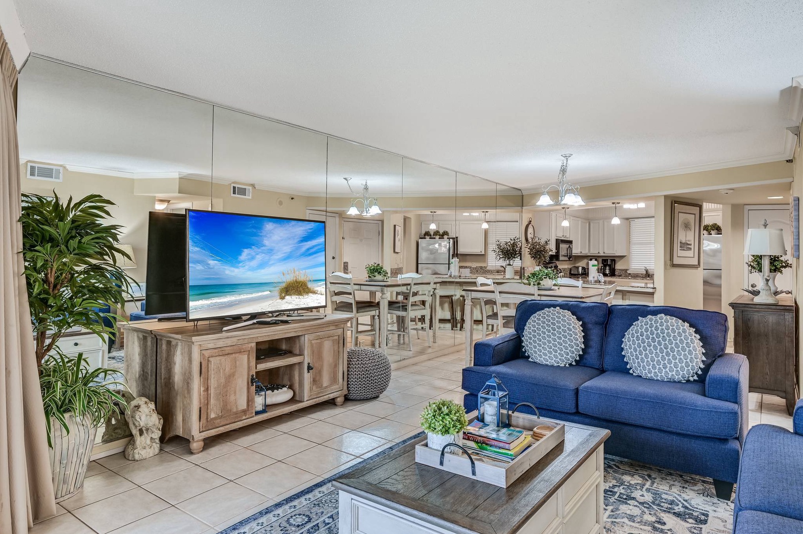 Open concept living area with TV balcony access and sleeper sofa