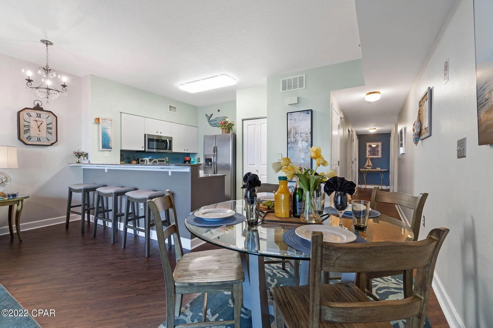 Dining area with table that seats 4 and breakfast bar seating 3.