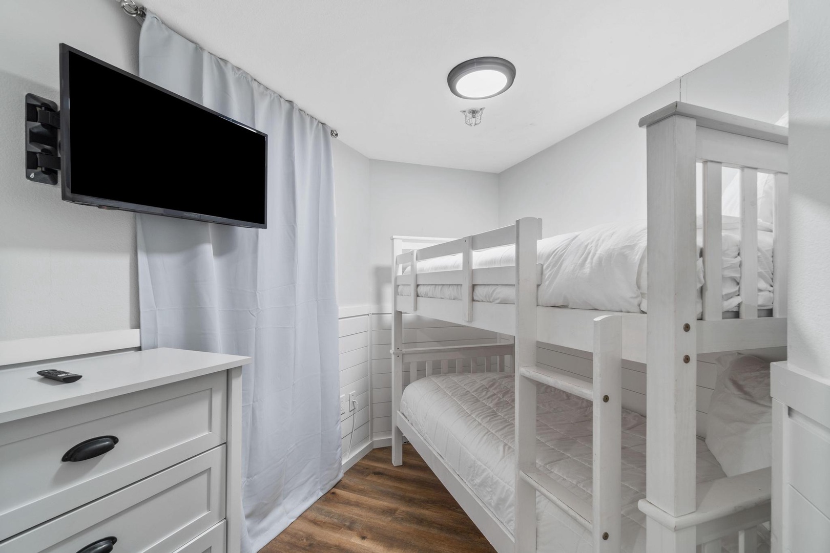 The bunk room has two twin beds and a half bathroom just steps away