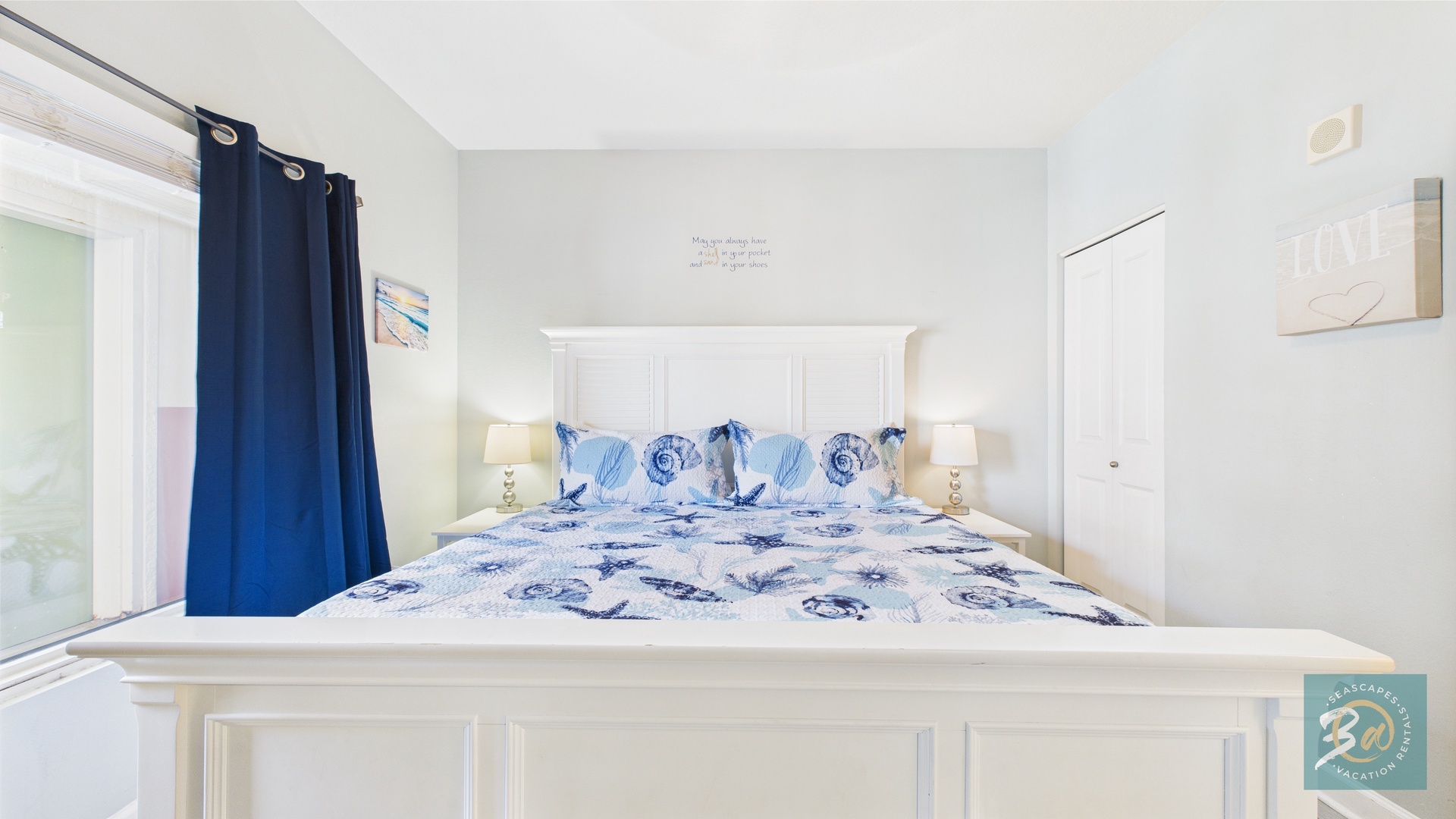 Master bedroom with king bed TV and ensuite bathroom