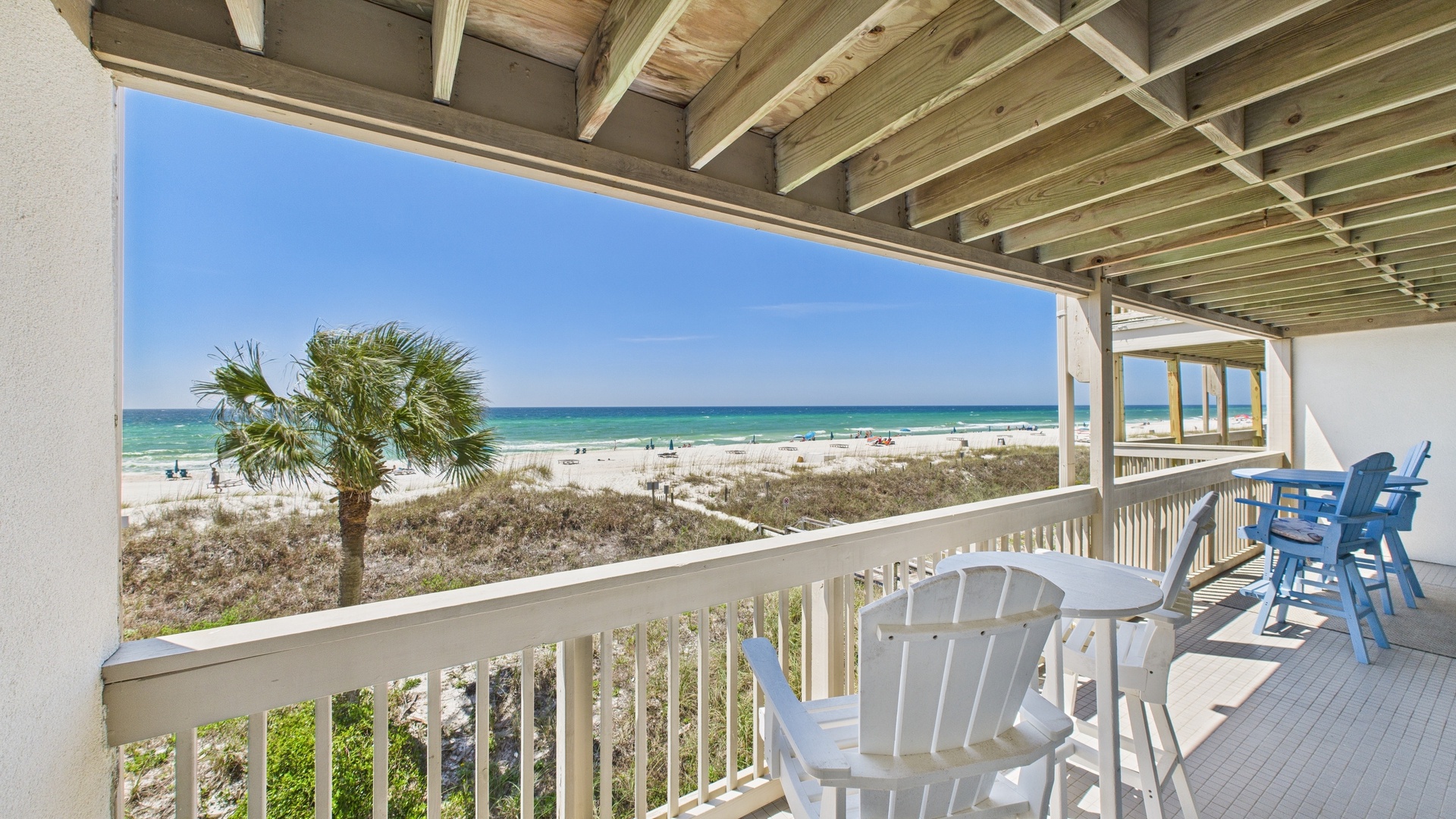Huge balcony with seating and tables with coastal views