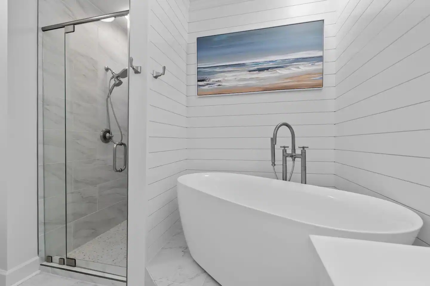 Primary bathroom with dual vanity bathtub and walk in shower