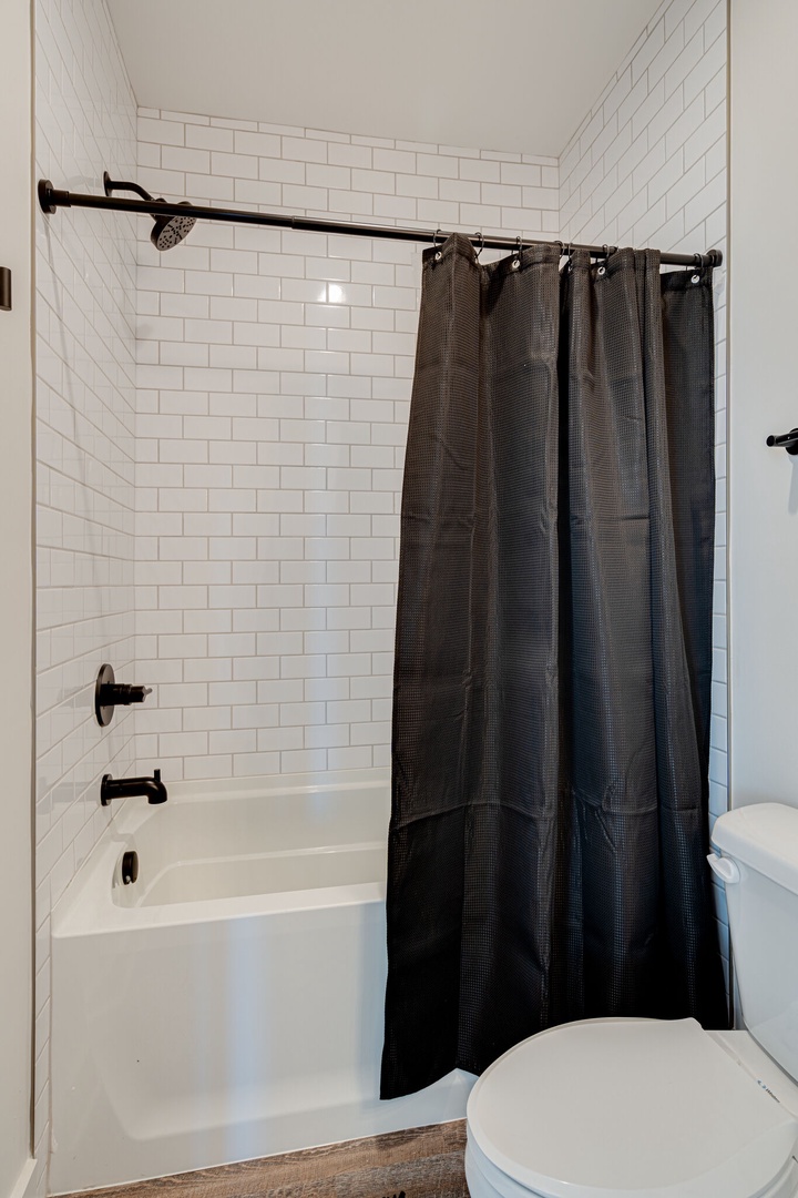 3rd bathroom that is adjacent to the 3rd bedroom. Located on the 2nd floor. Can also be used as communal bathroom for guests in living area/kitchen. Bathroom features a shower and tub combo.