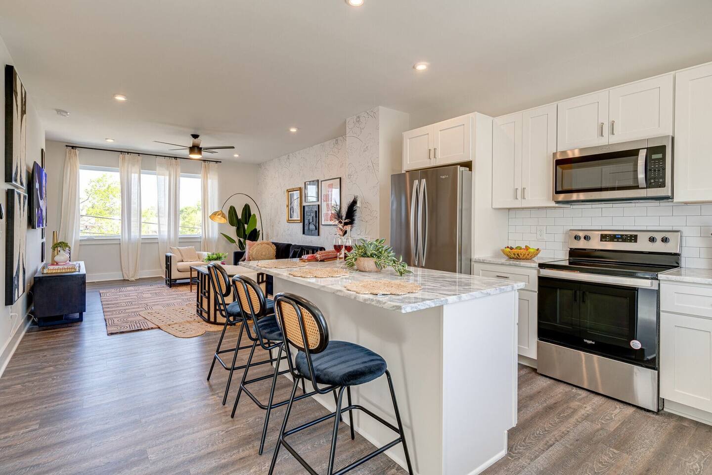 5629 - Open kitchen with stainless steel appliances, large island, breakfast bar seating, and is fully equipped with your basic cooking essentials.