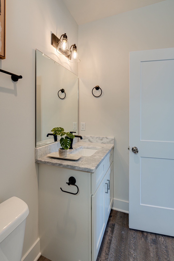 4th bathroom that connects to the 4th bedroom. Bathroom features a combo/tub shower.