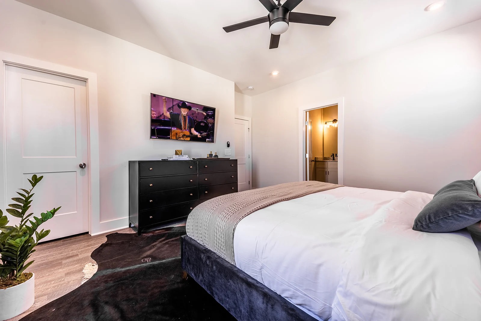 Master bedroom with king bed and TV