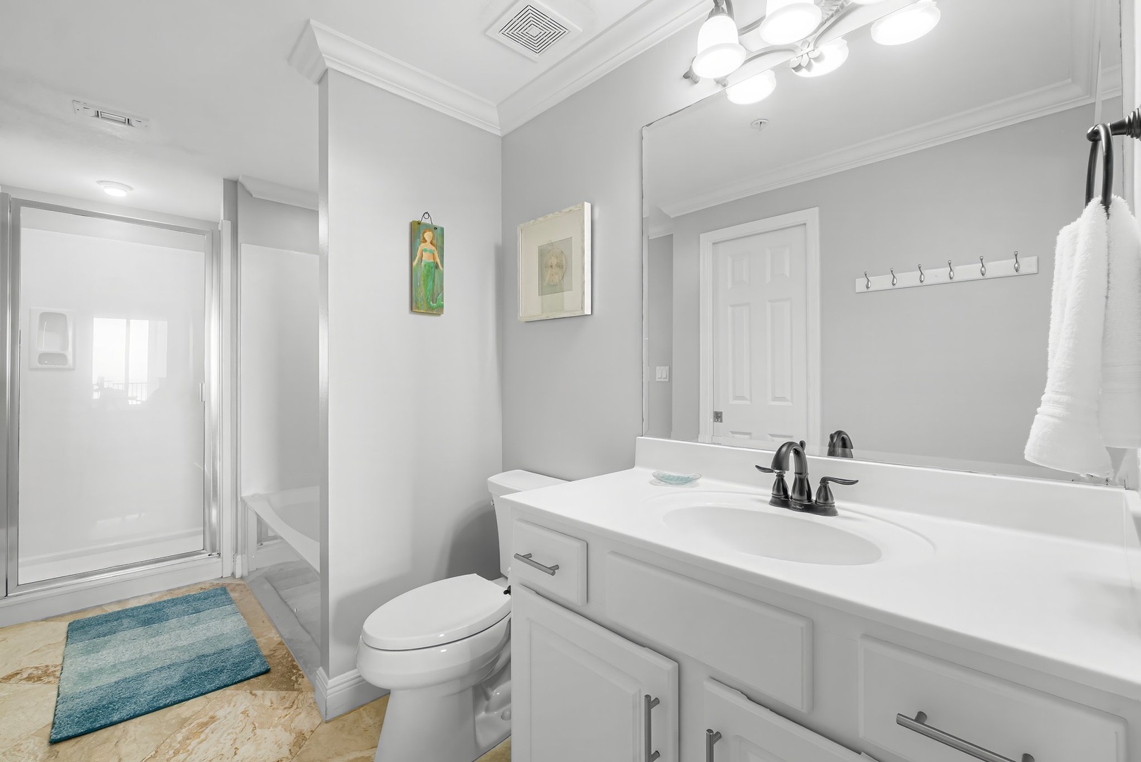 Primary bathroom with shower and tub combo and walk in shower