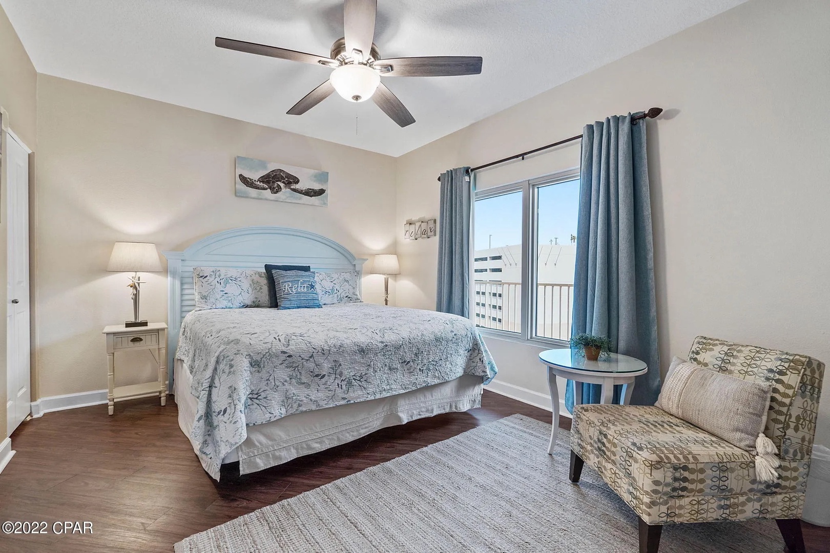 Primary bedroom with king bed, TV, and scenic views. Features an ensuite bathroom.