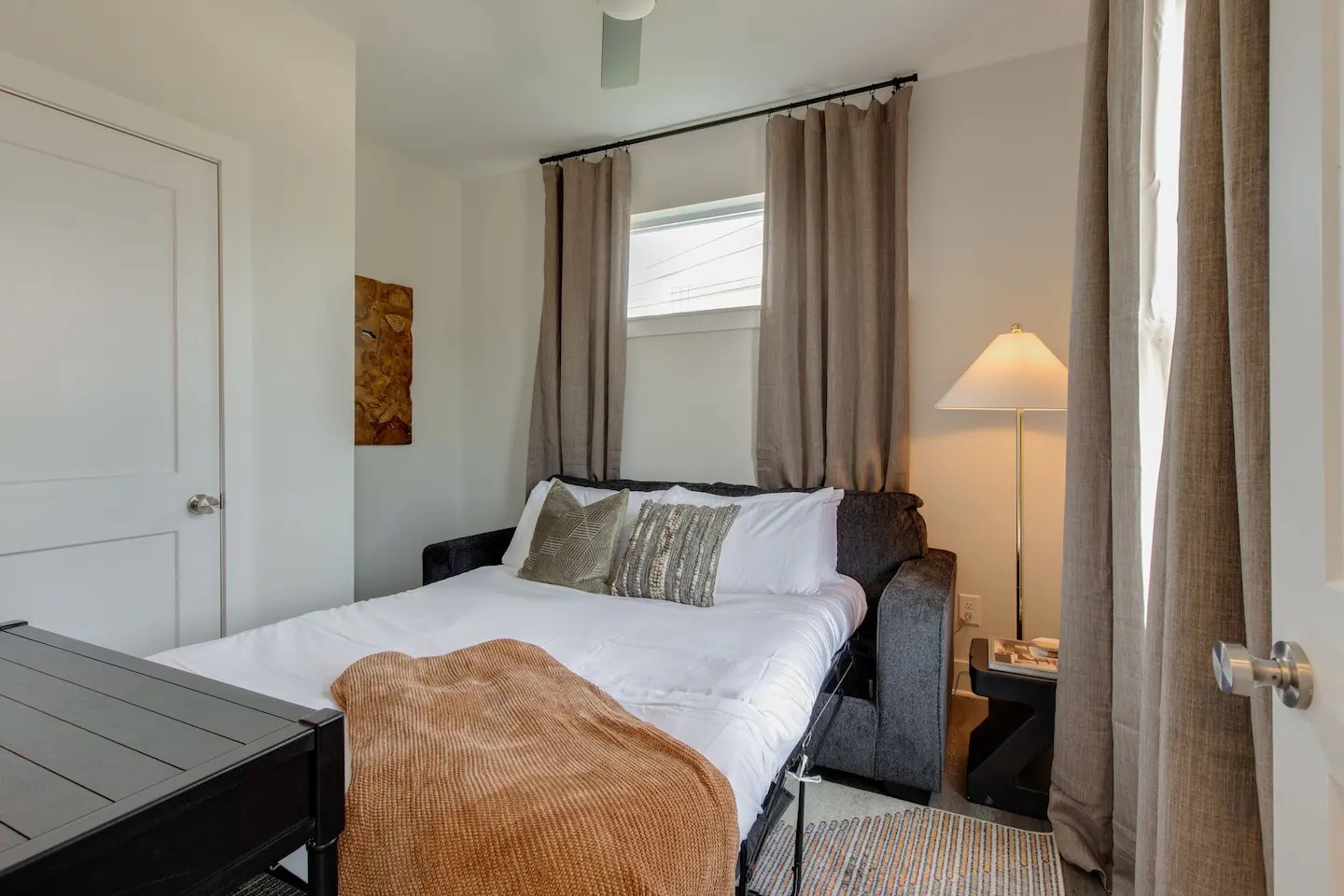 5631 - 3rd Bedroom / Office featuring a pull-out couch and workstation.