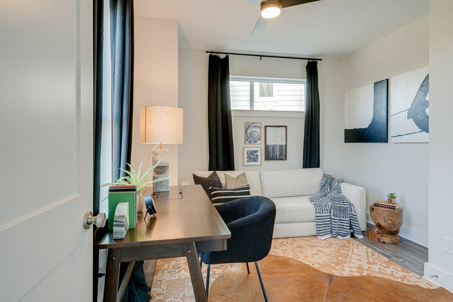 5627 - Common space with desk for work and fold out queen sleeper sofa.