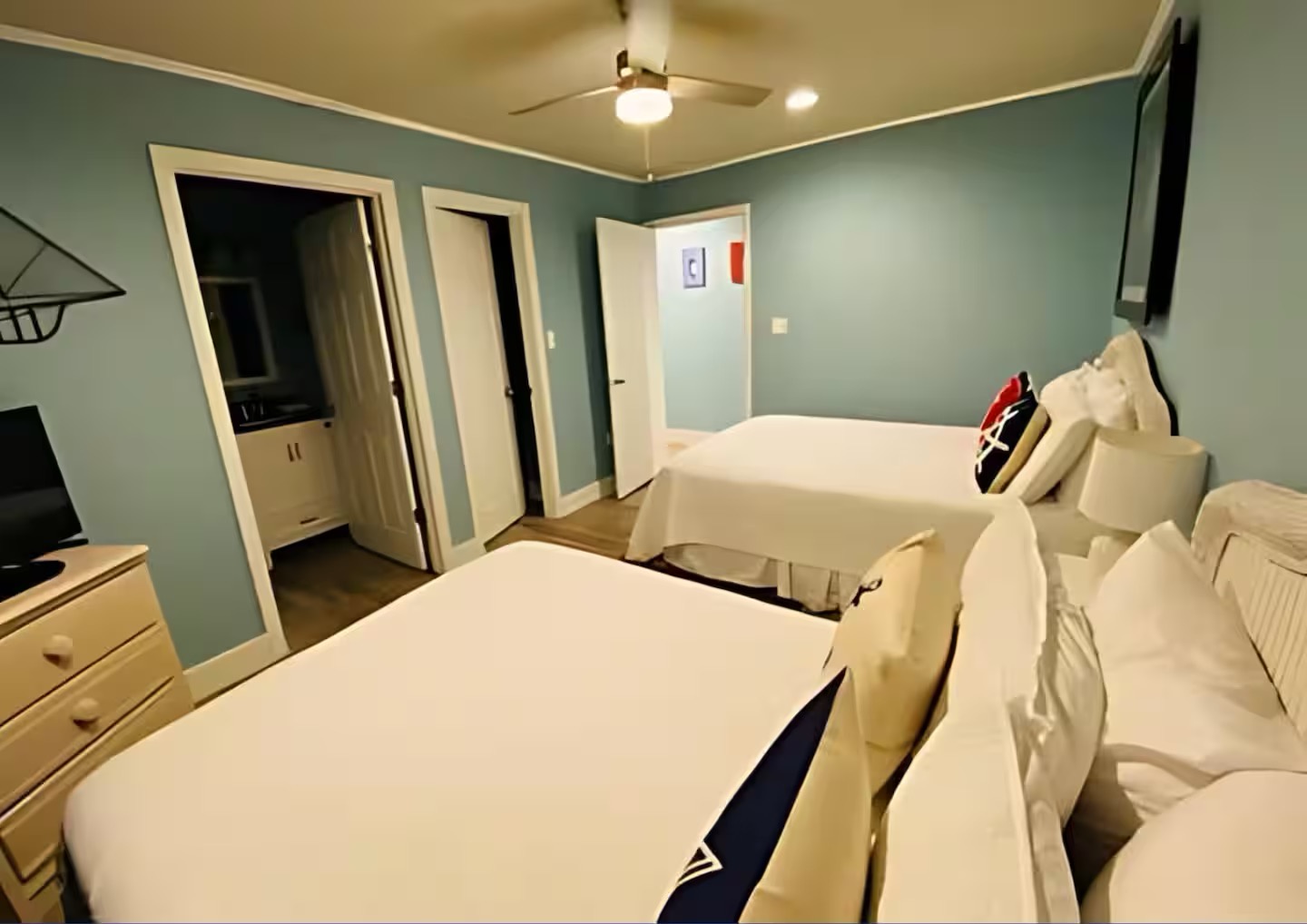 Guest bedroom with two full beds TV and ensuite bathroom
