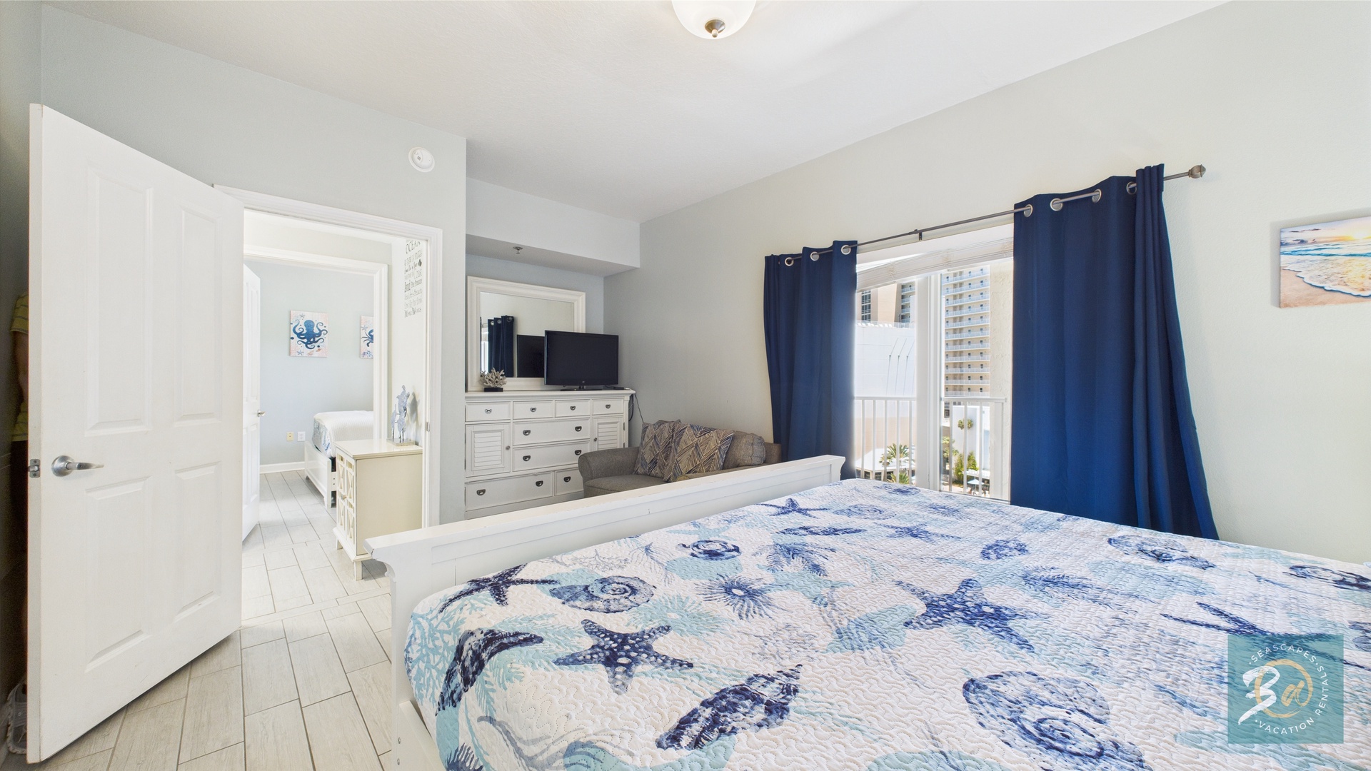 Master bedroom with king bed TV and ensuite bathroom