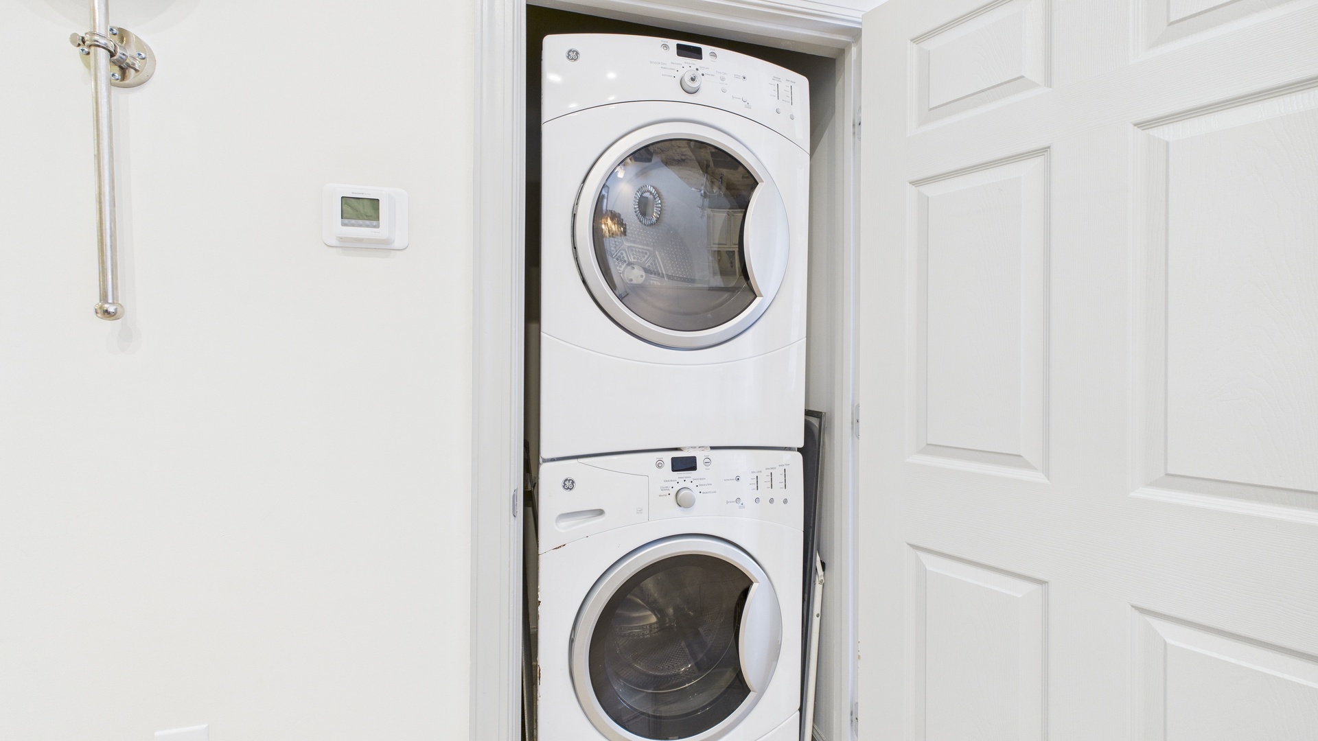Washer and dryer machines in hallway closet