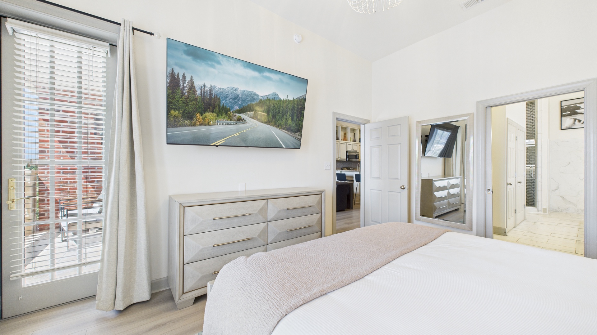 Master bedroom with king size bed and tv screen