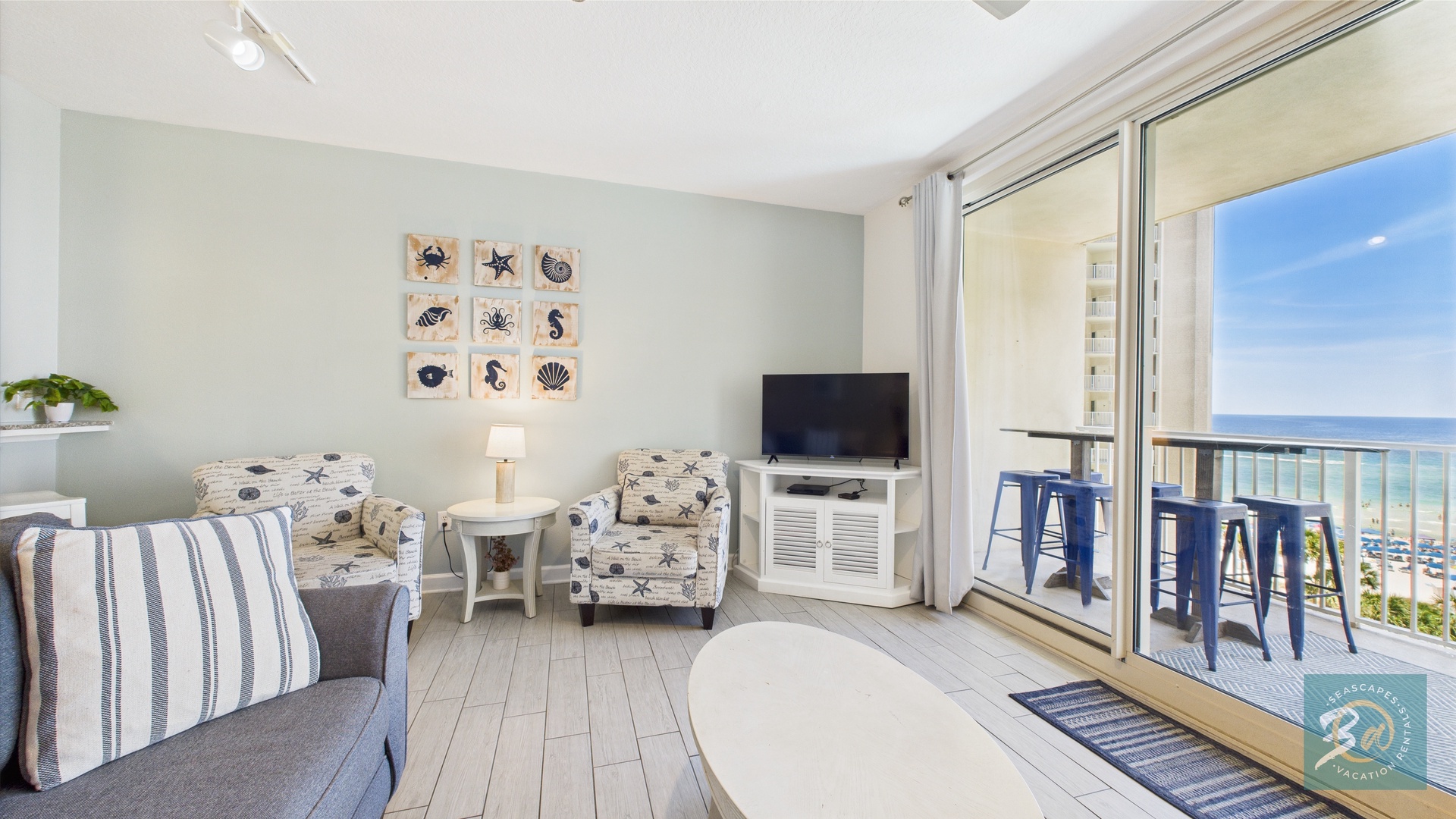 Open concept living area with stylish furnishings TV and balcony access