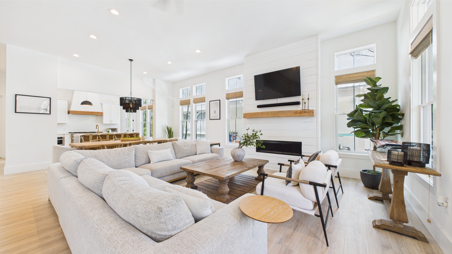 Open concept living area with stylish furnishings and huge TV