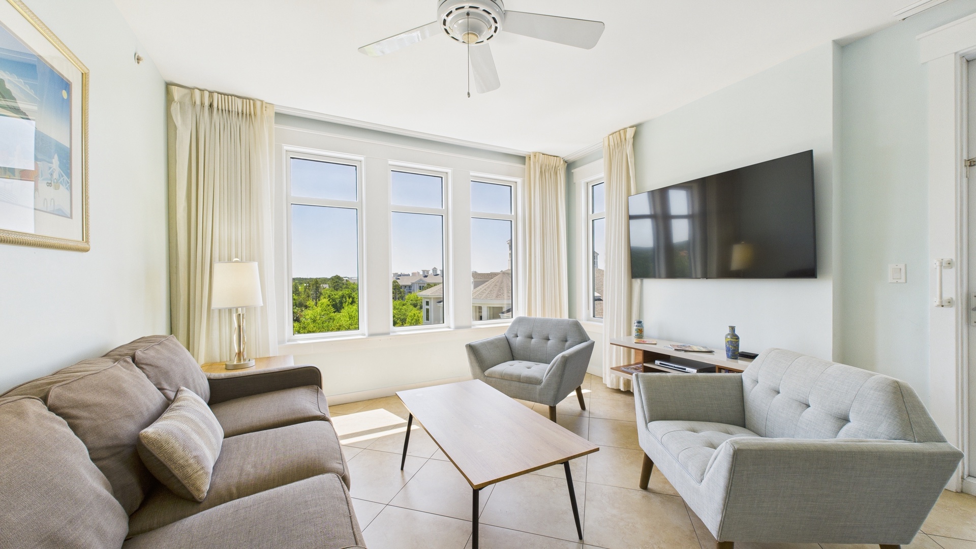 Open concept living area with stylish furnishings TV and sofa bed