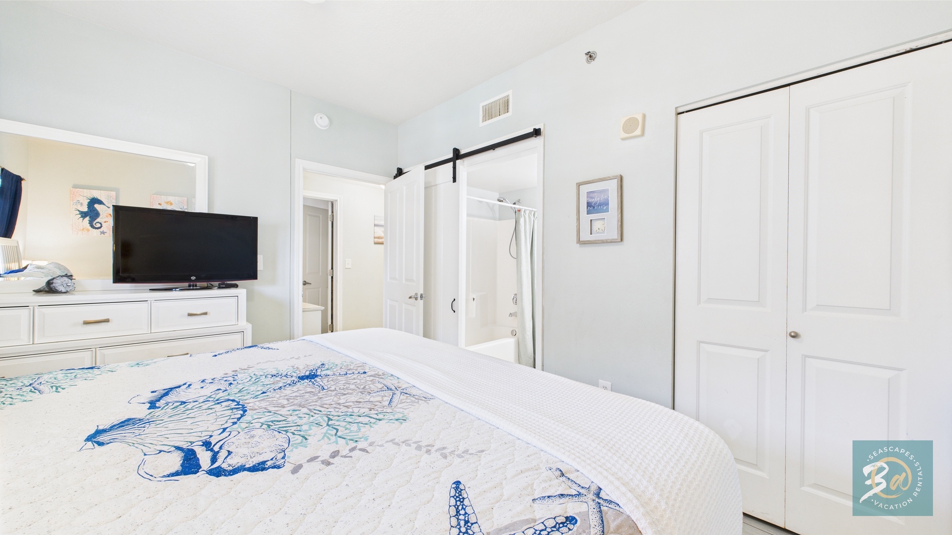 Guest bedroom with queen bed TV and ensuite bathroom