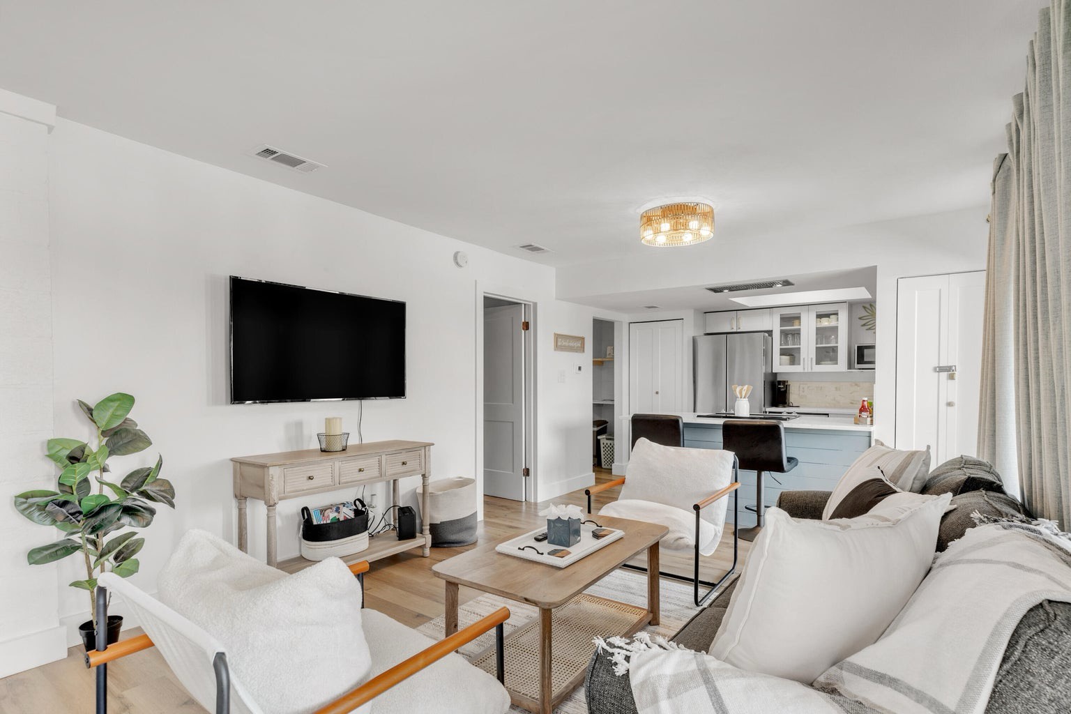 Open concept living area with stylish furnishings TV and pull out couch