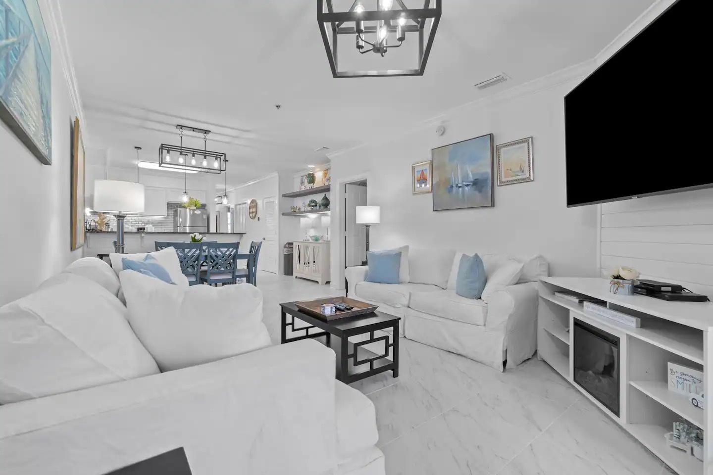 Open concept living area with stylish furnishings balcony access and sofa bed