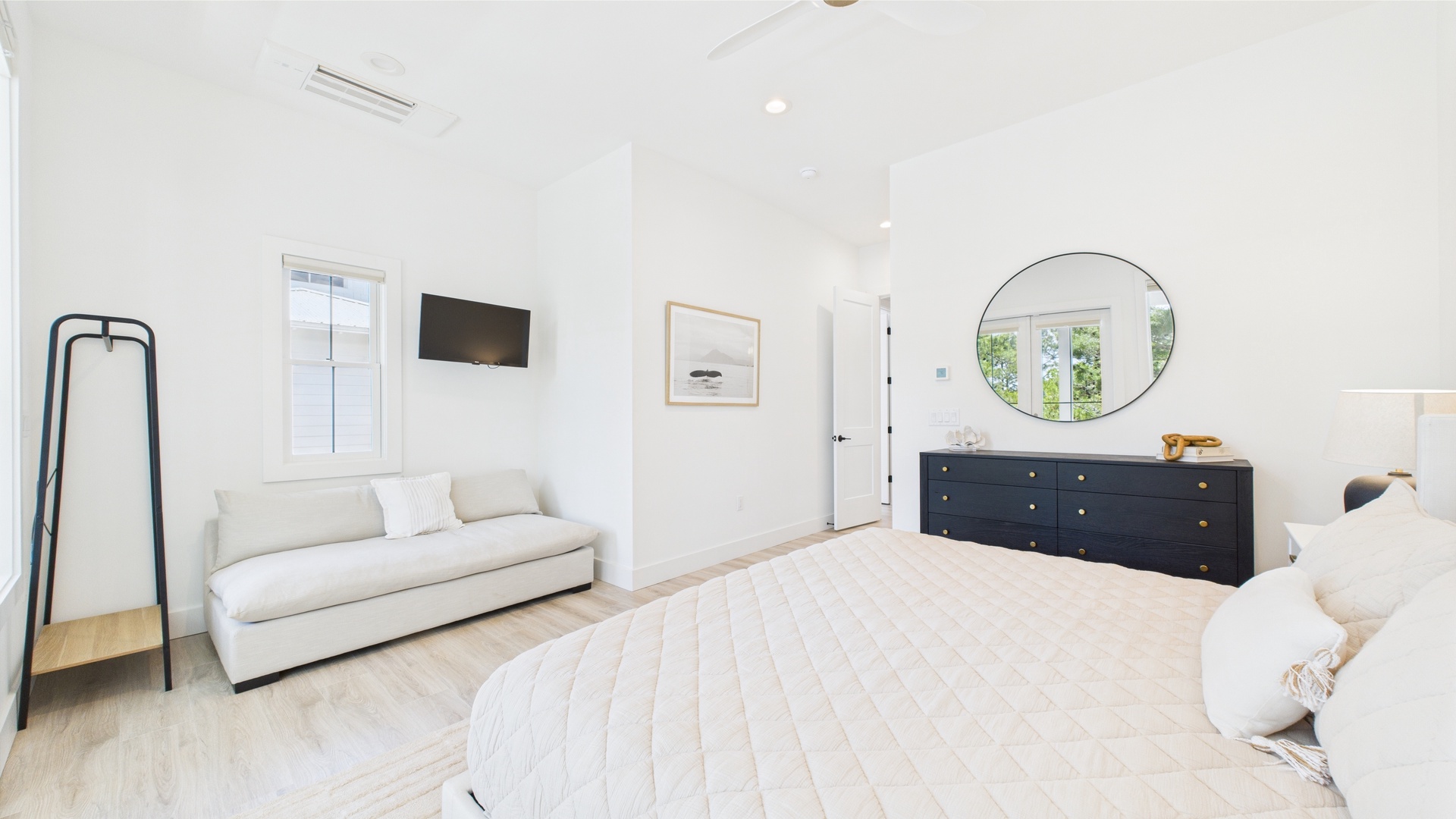 Master bedroom with king bed TV and ensuite bathroom