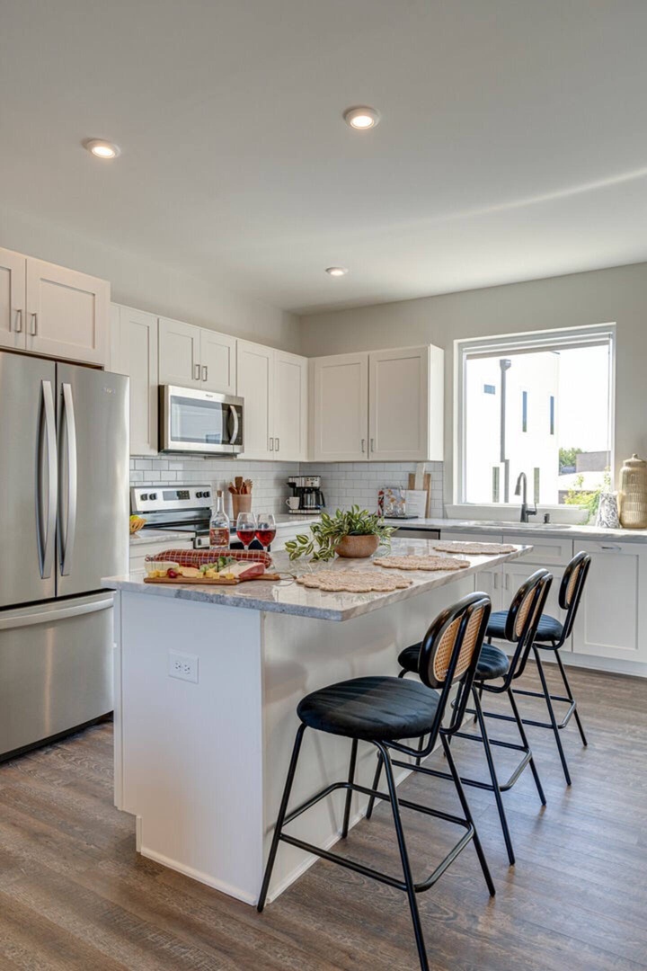 5629 - Open kitchen with stainless steel appliances, large island, breakfast bar seating, and is fully equipped with your basic cooking essentials.