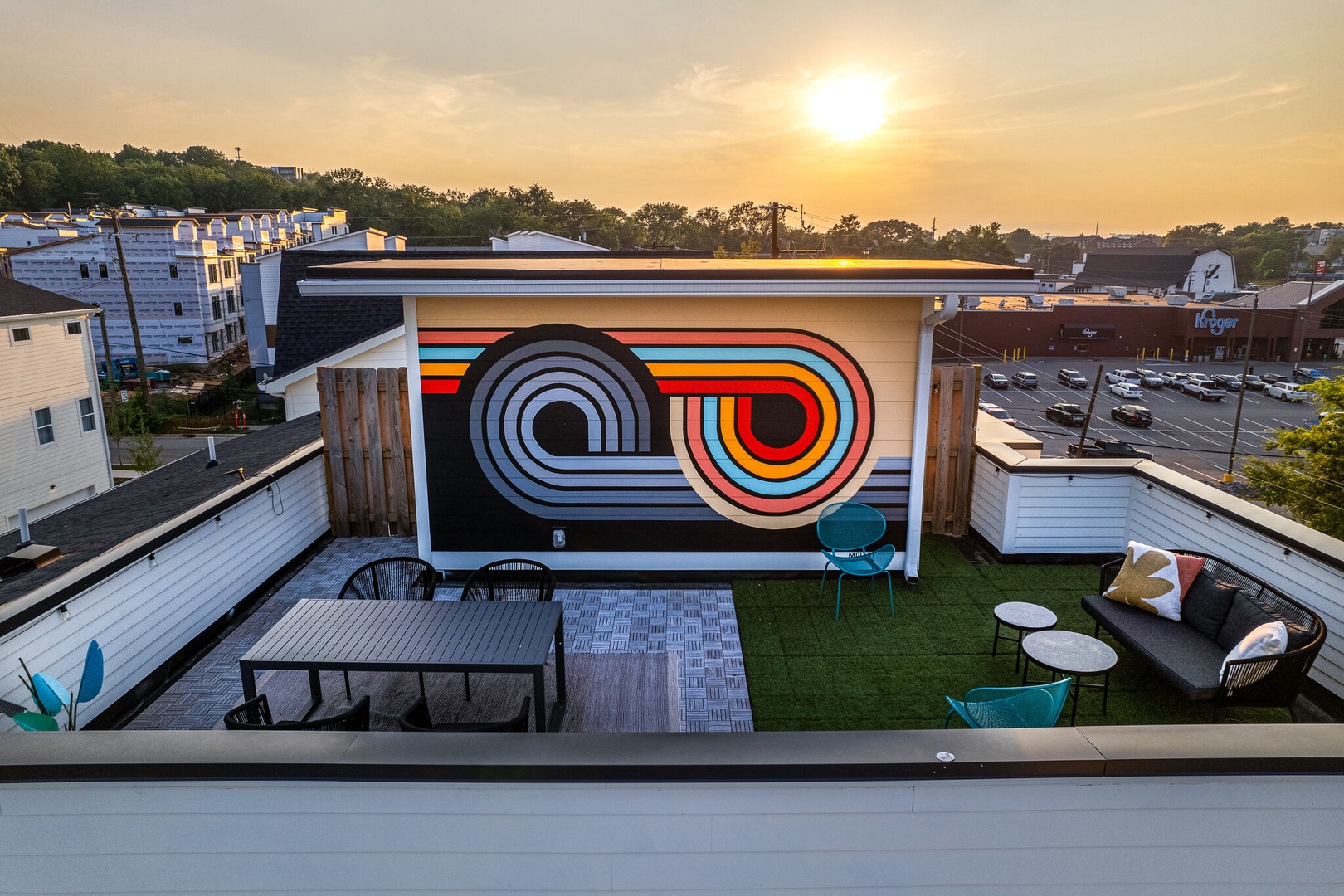 Private rooftop deck outdoor dining table (seats 4) and lounge area. Entire space is lined with bistro lights and includes a photo op mural!