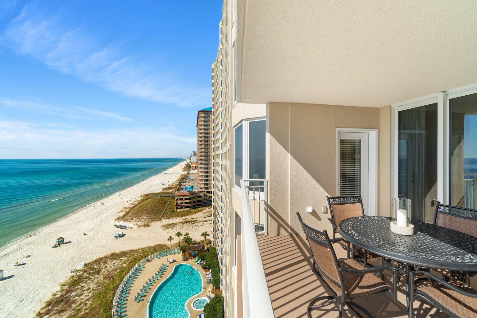 Balcony with dining table and coastal views