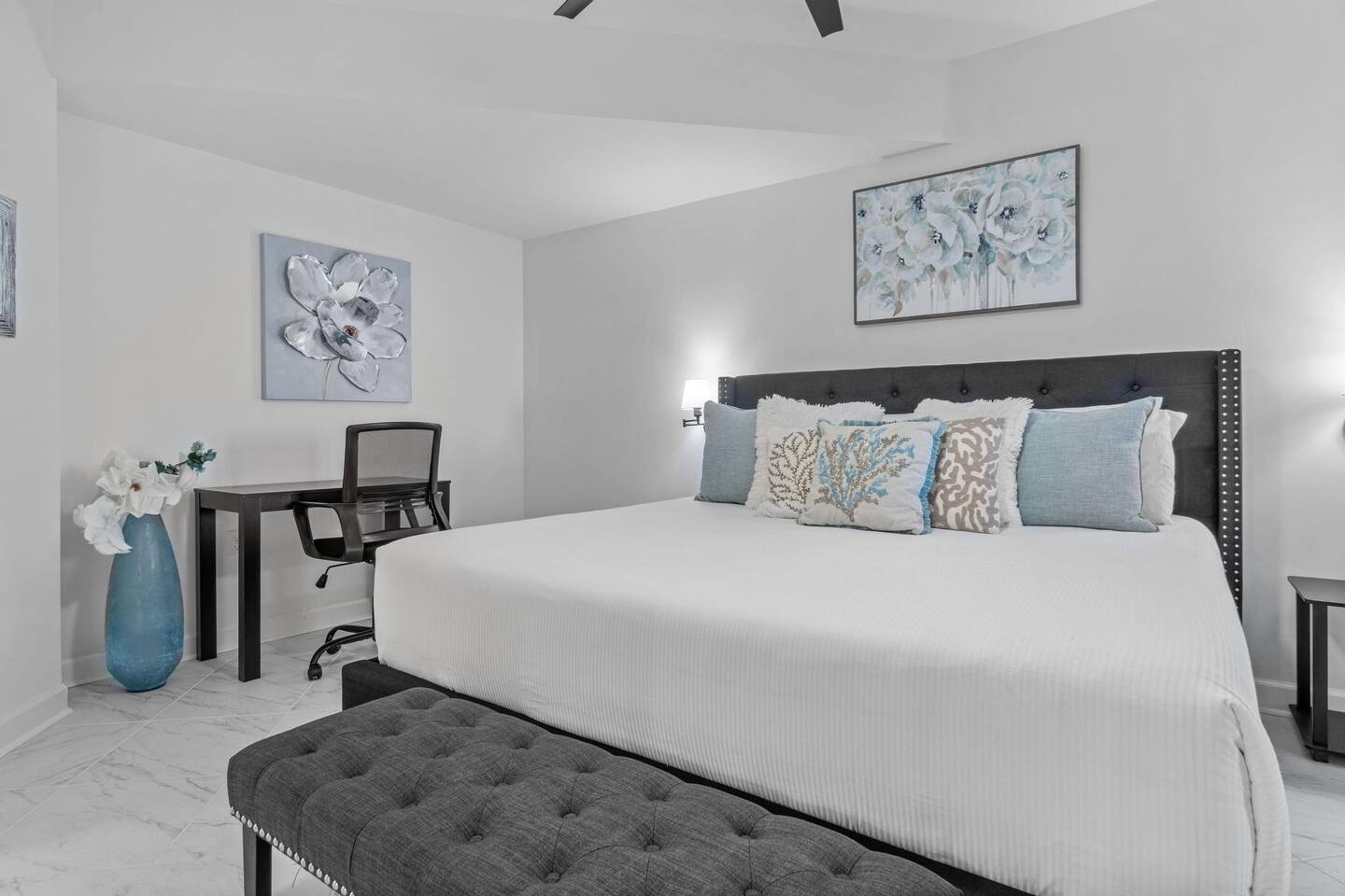 Primary bedroom with king bed desk and ensuite bathroom