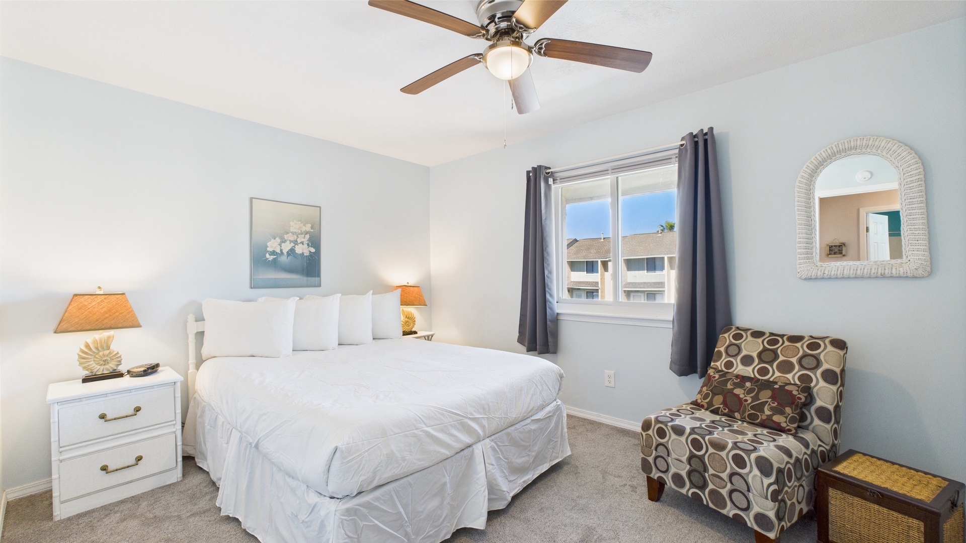 Primary bedroom with queen bed TV and easy bathroom access