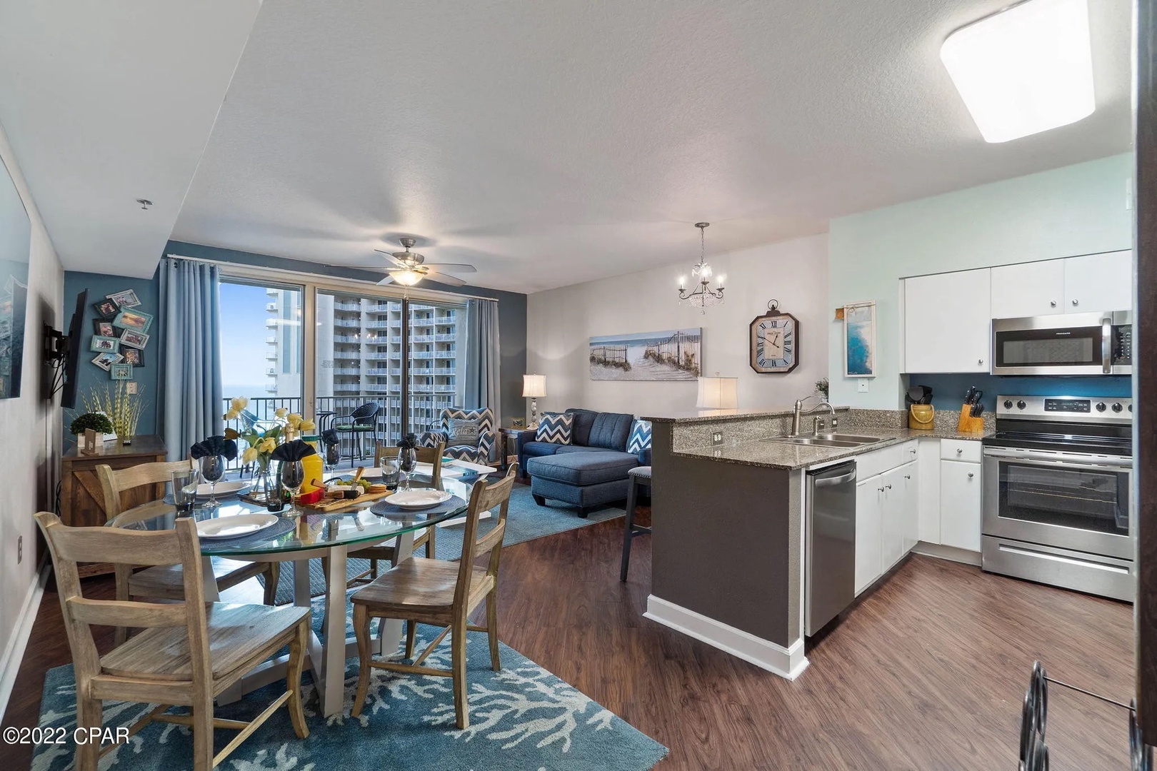 Open concept living area with stylish furnishings, TV, and scenic views. Features a queen size pullout sofa as well.