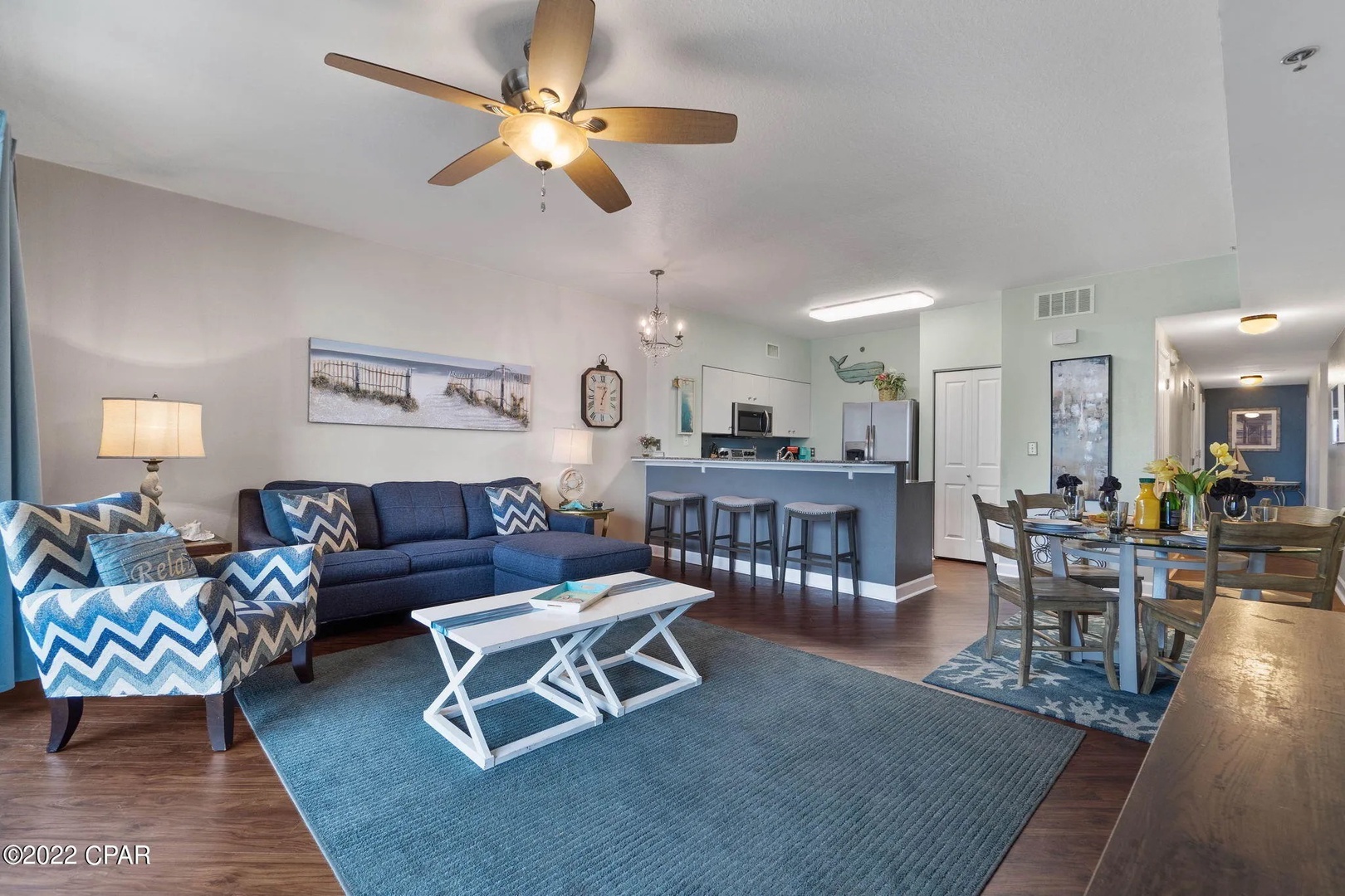 Open concept living area with stylish furnishings, TV, and scenic views. Features a queen size pullout sofa as well.
