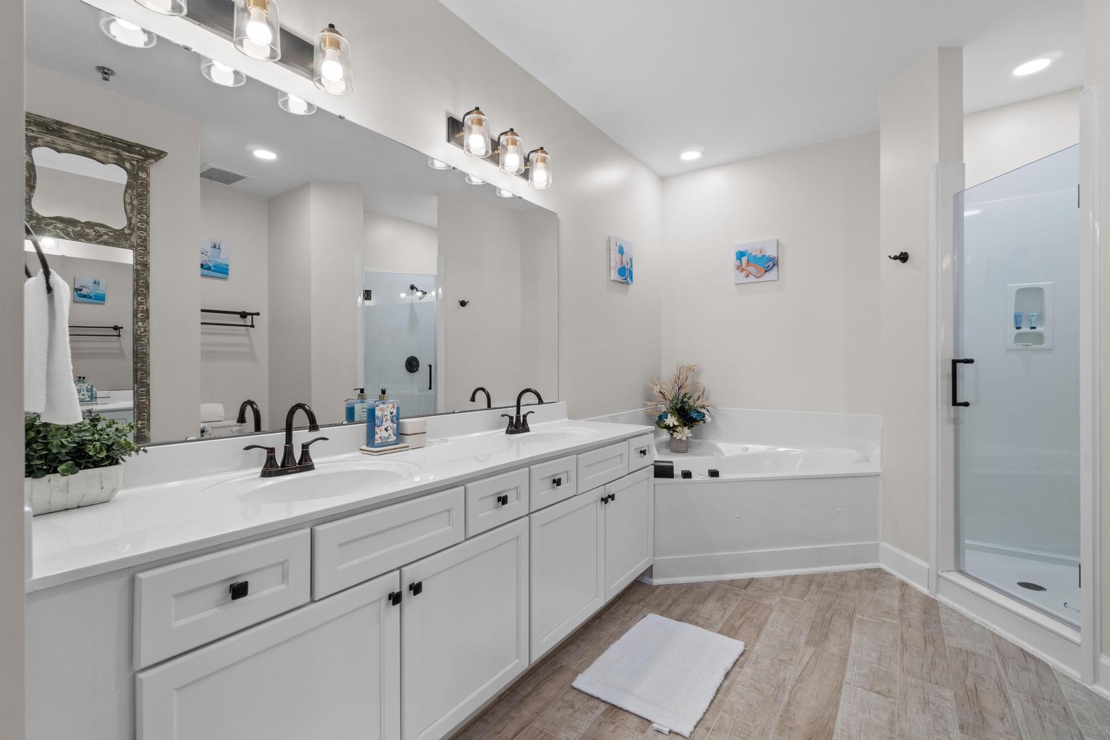 Master bathroom with custom double vanity and a large walk in shower and a jetted tub