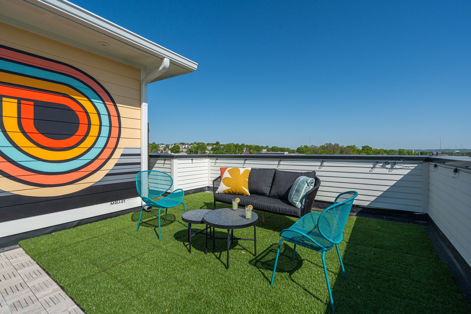 Private rooftop deck outdoor dining table (seats 4) and lounge area. Entire space is lined with bistro lights and includes a photo op mural!
