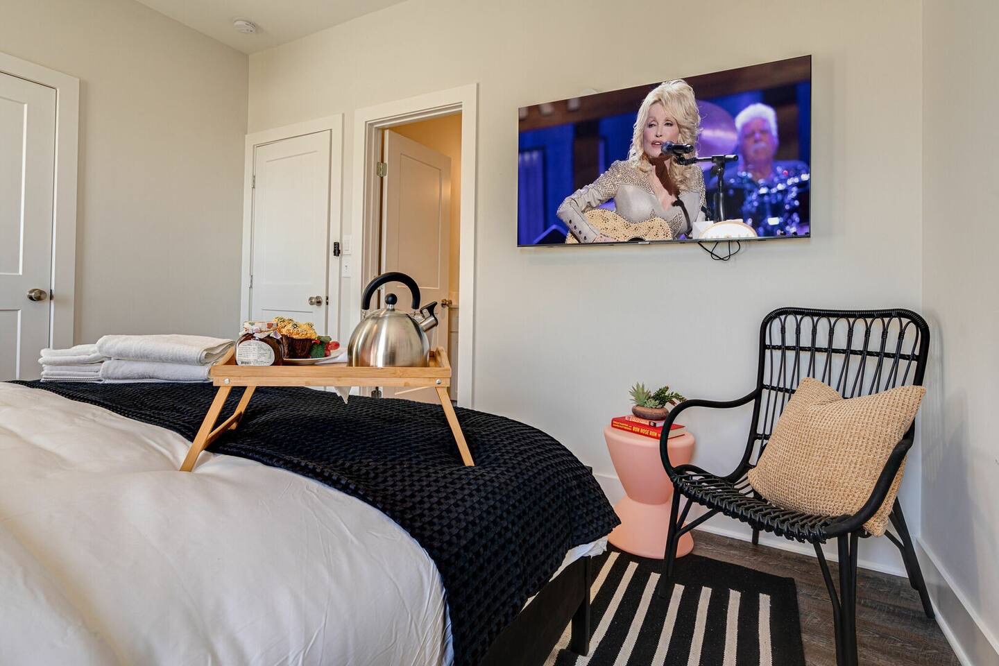 5629 - Primary bedroom with King bed, designer furnishings, smart TV, and ensuite bathroom.