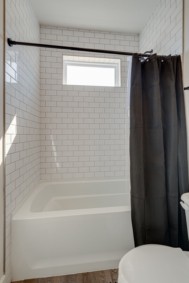 2nd bathroom that is connected to the 2nd bedroom. Features a shower and tub combo.