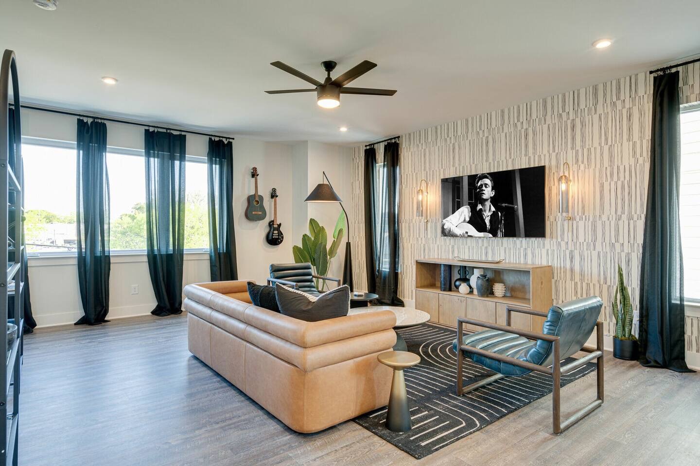 5627 - Open concept living area with stylish furnishings and smart TV.