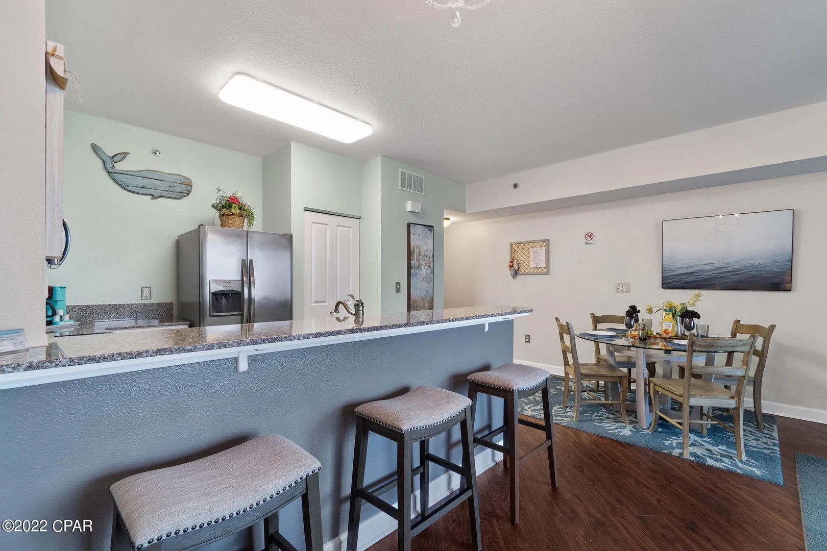 Full kitchen and breakfast bar with seating for 3.