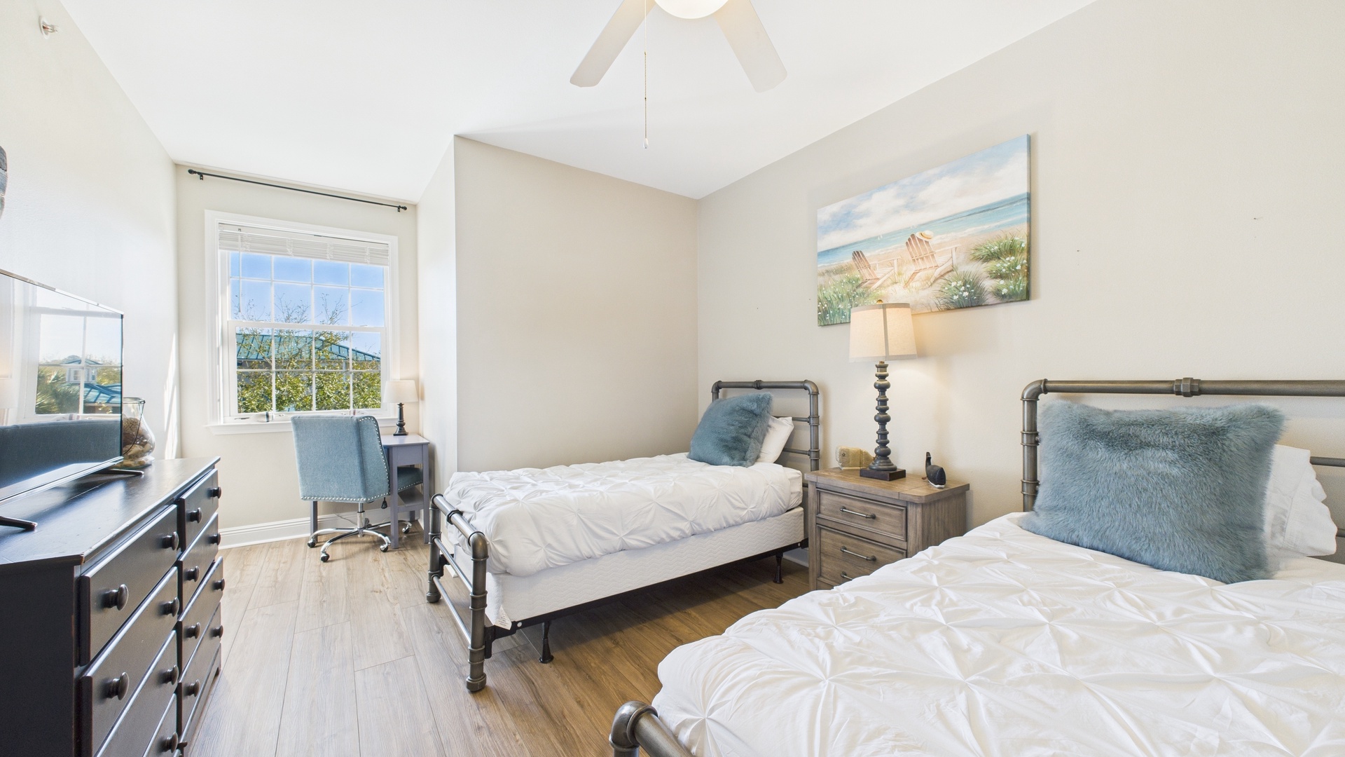 Guest bedroom with two twin beds and desk