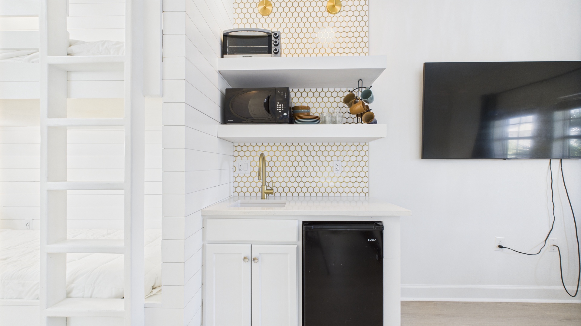 Kitchenette equipped with mini fridge microwave and toaster oven