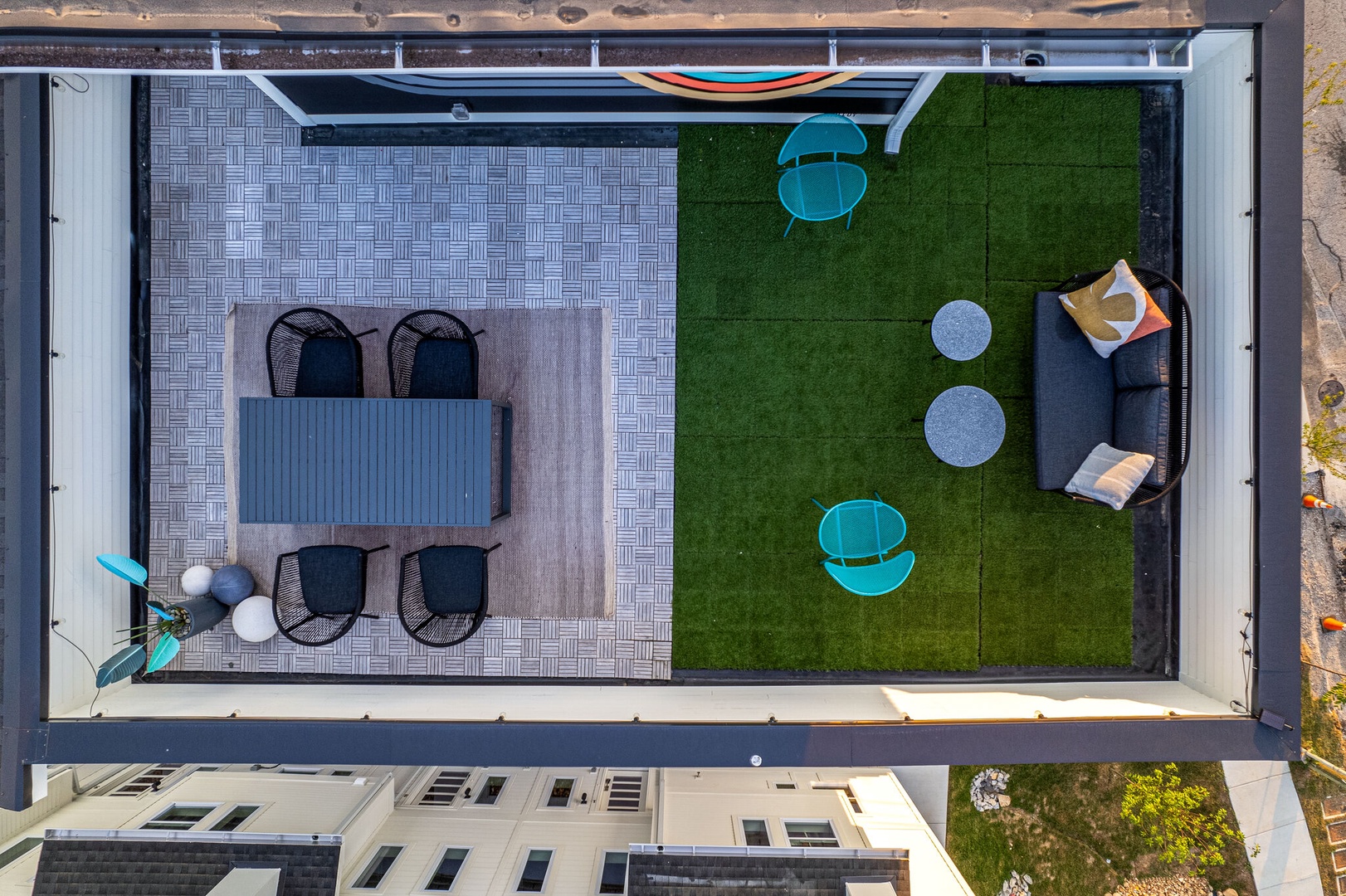 Private rooftop deck outdoor dining table (seats 4) and lounge area. Entire space is lined with bistro lights and includes a photo op mural!