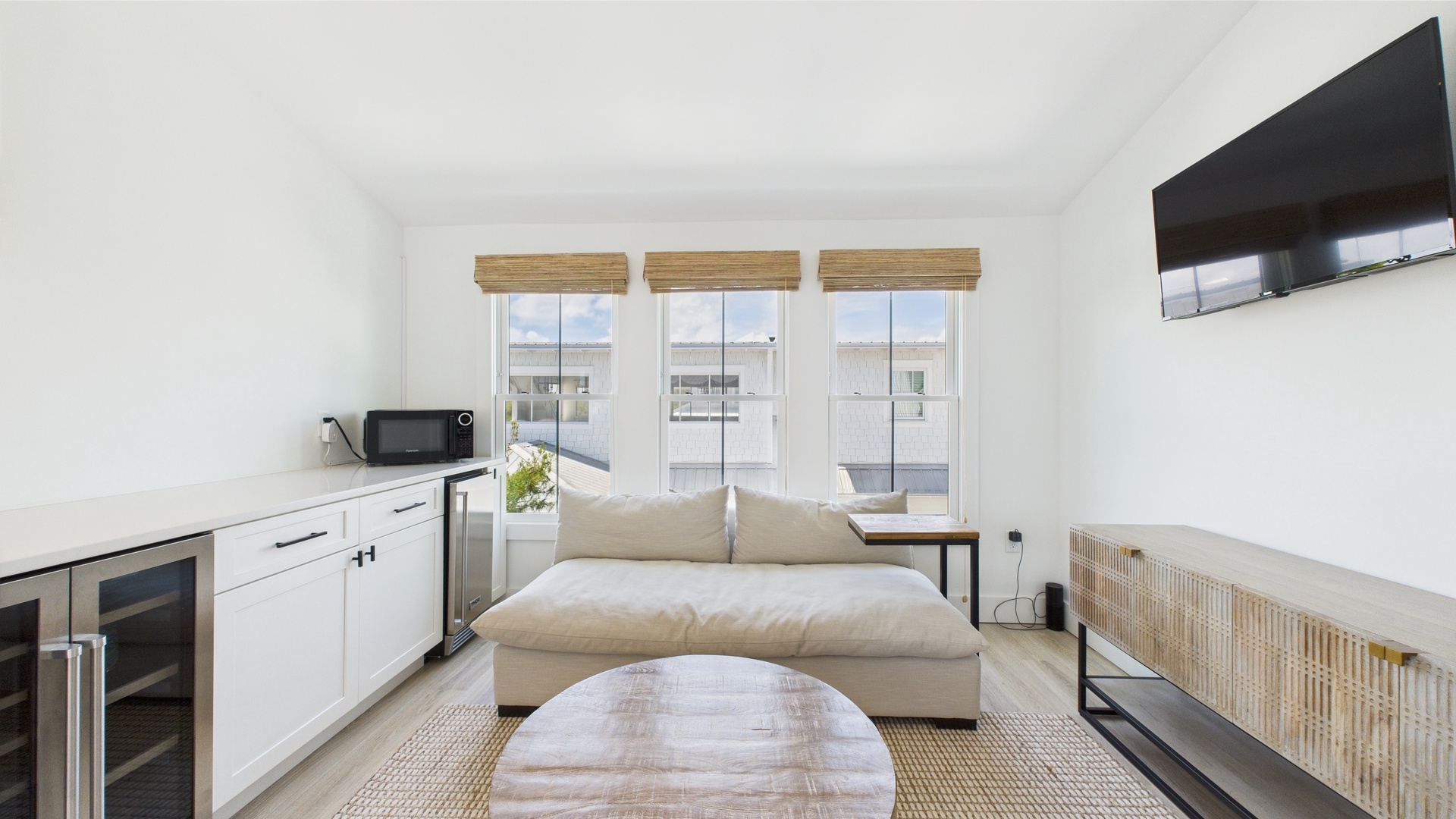Third floor living area with kitchenette TV and murphy bed
