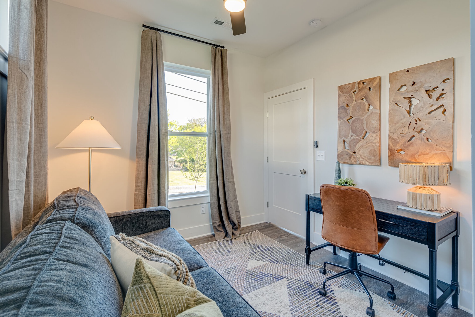 3rd Bedroom / Office featuring a pull-out couch and workstation.